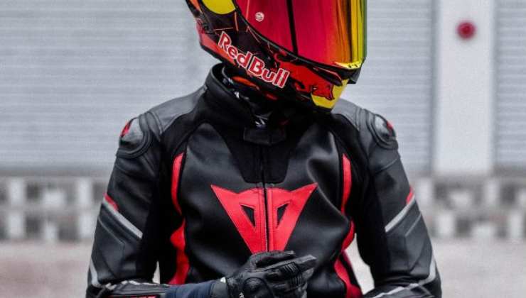 Un motociclista casco, tuta e guanti