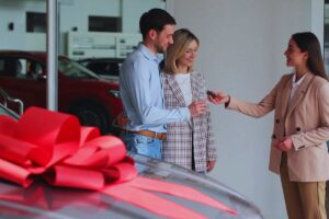 Venditrice che consegna chiavi auto ad acquirenti